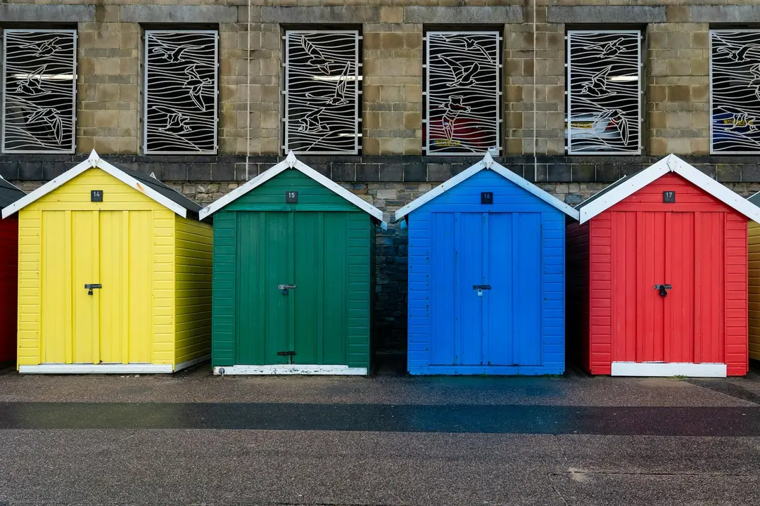 Row of doors painted yellow, green, blue and red
